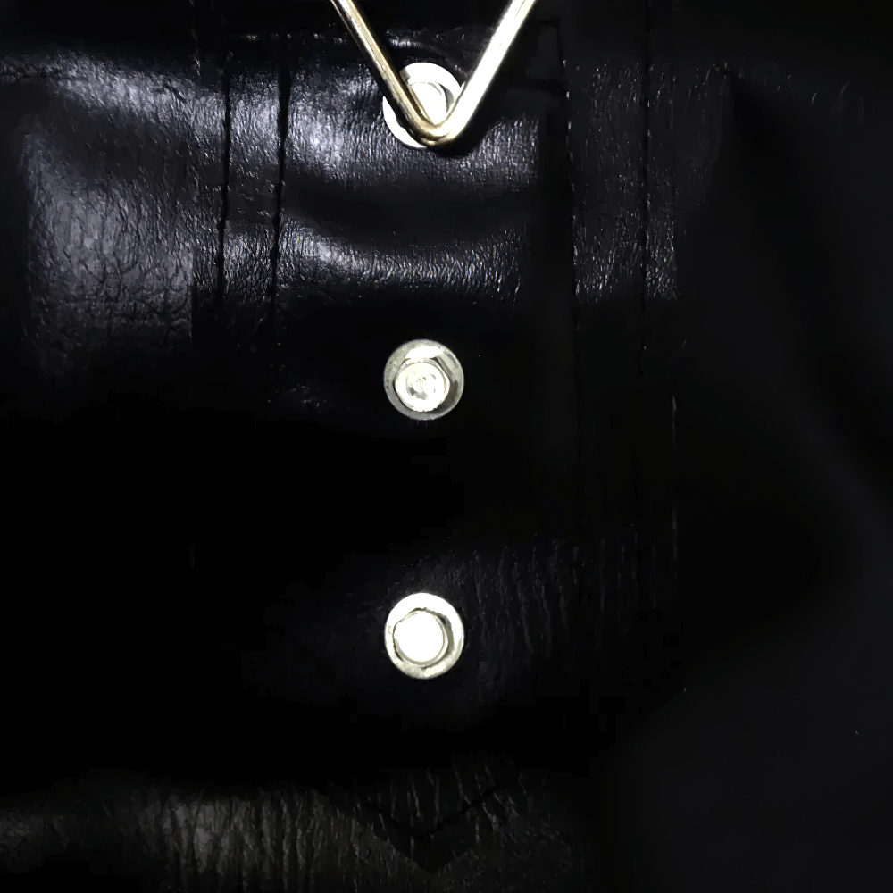 Close-up of a hanging punching bag's reinforced chain and stitching for boxing and MMA training, made of tough synthetic leather.