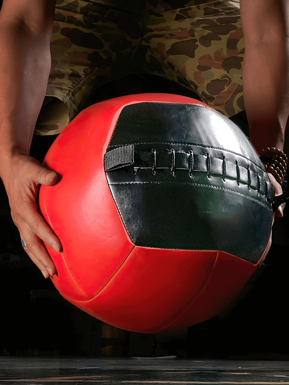 Heavy-duty red and black medicine ball for strength, core training, and CrossFit. Ideal for home gym workouts and explosive movements.