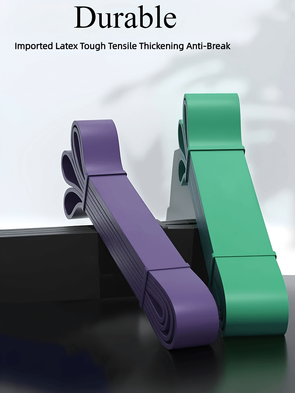 Purple and green heavy-duty latex resistance bands for strength training and workouts, emphasizing durability and anti-break design.