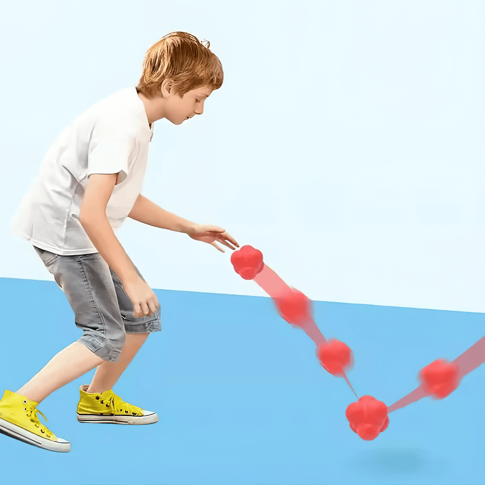 Boy playing with hexagonal reaction ball for reflex and coordination training, showcasing unpredictable bounce on blue floor.