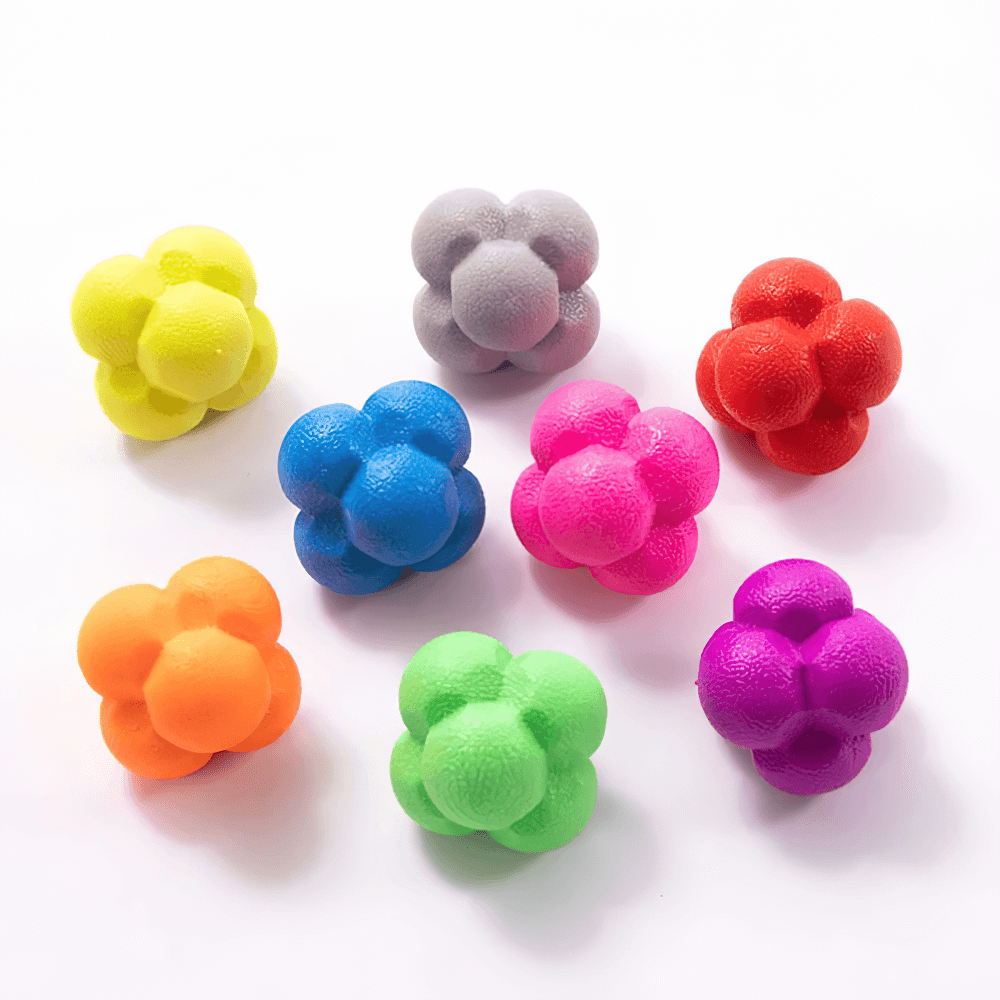 Colorful hexagonal reaction balls for reflex training scattered on a white background, ideal for agility and hand-eye coordination exercises.