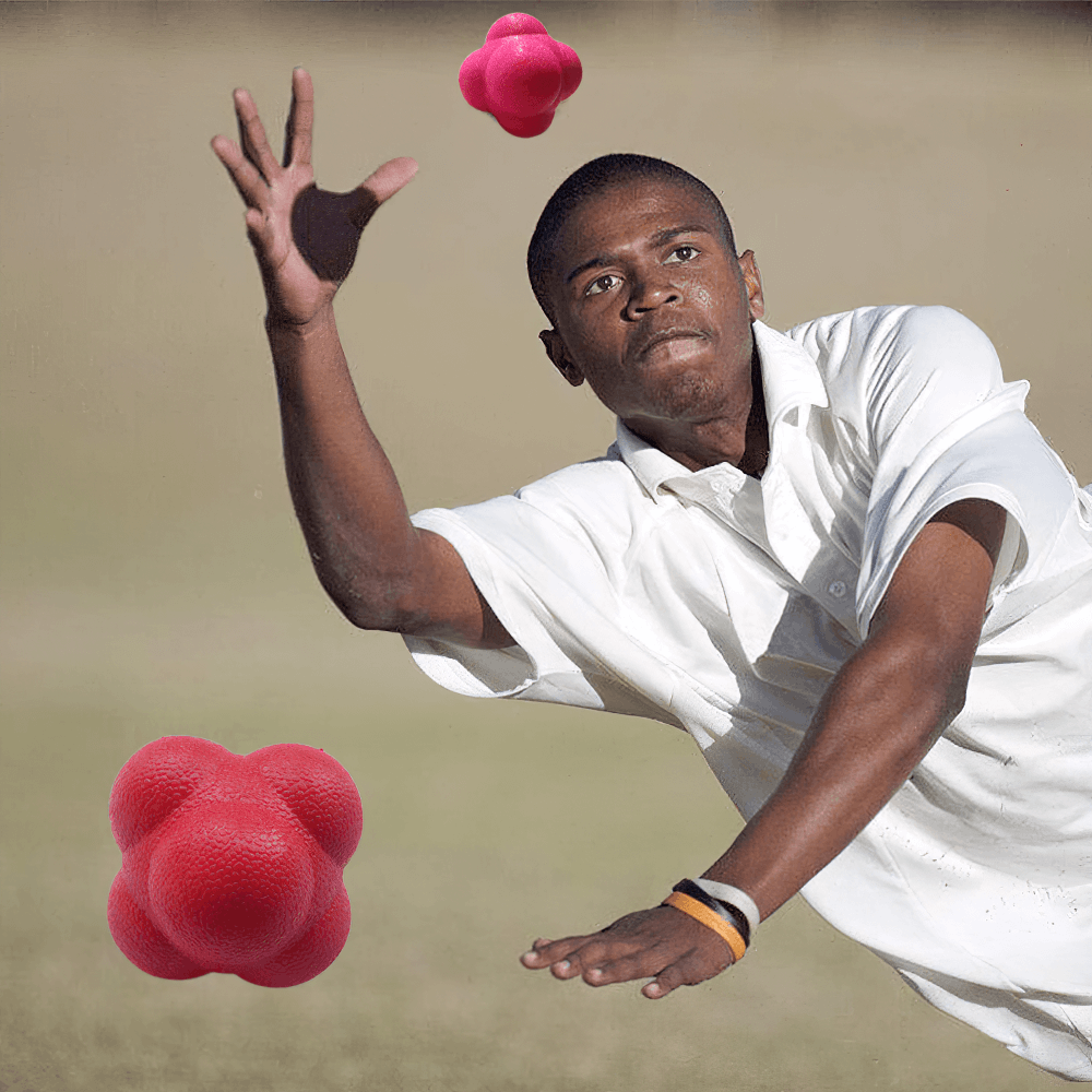 Athlete catching a red hexagonal reaction ball during agility training outdoors for hand-eye coordination and reflex development.
