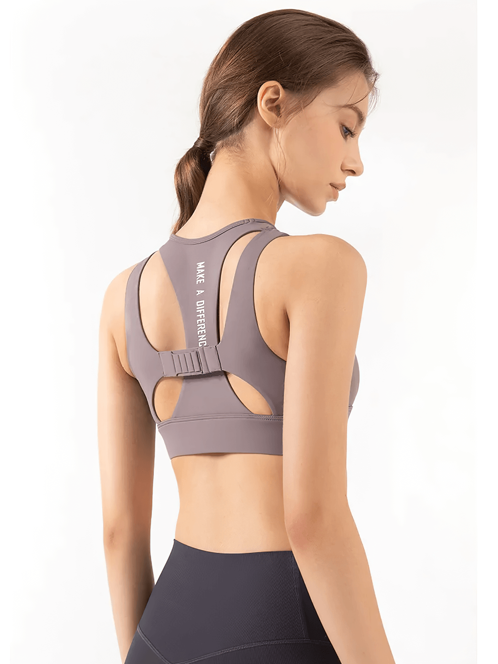 Woman wearing a high-impact yoga crop top with quick-dry fabric and fixed pad support, ideal for active sports sessions.