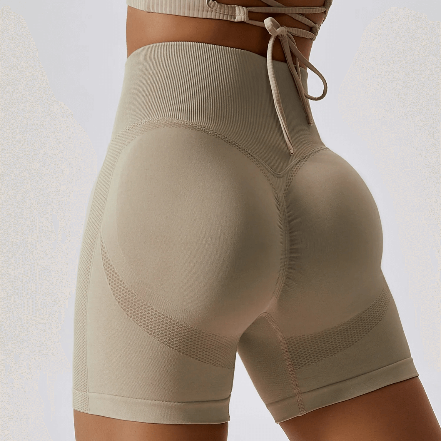 High-performance nylon spandex yoga shorts in beige, showcasing flexibility and style for athletic activities like yoga and running.