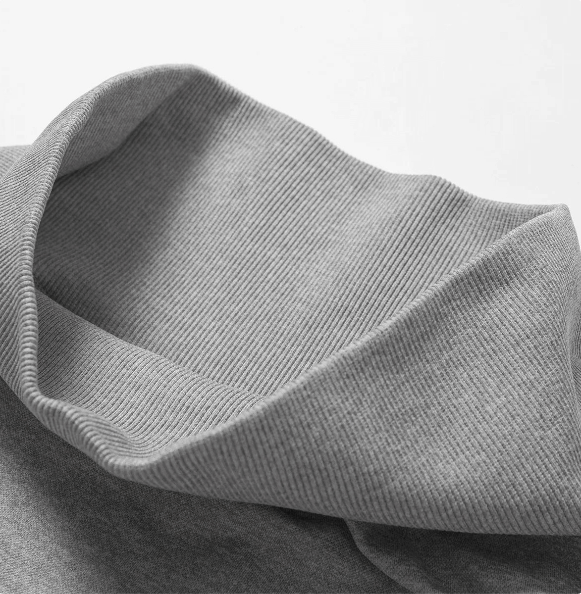 Close-up of a gray ribbed sweater collar in soft, cozy knit fabric.