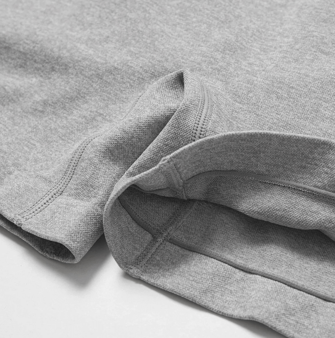 Close-up of gray high-performance nylon spandex yoga shorts fabric showcasing its durable, elastic, and versatile texture for workouts.