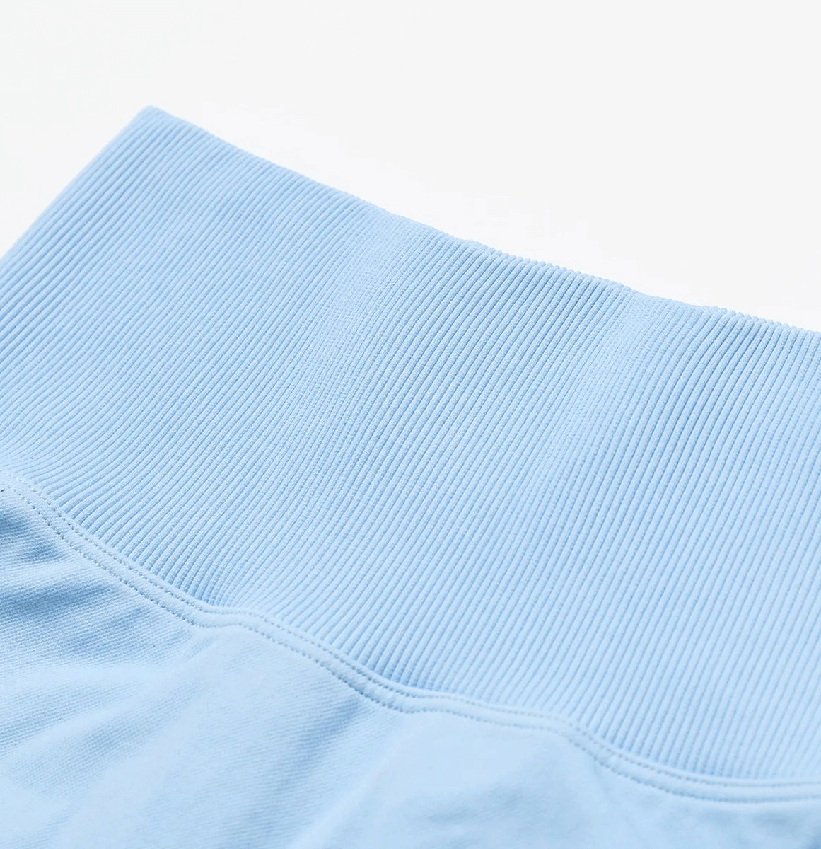 Close-up of high-performance nylon spandex yoga shorts in light blue, showcasing elastic waistband. Perfect for yoga, running, cycling.