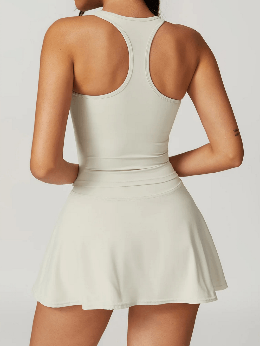 Alt Tag: High Waist Fitness Skirt with Hidden Inner Shorts - SF4433 back view, high-waist tennis skort with racerback top, flared mini skirt