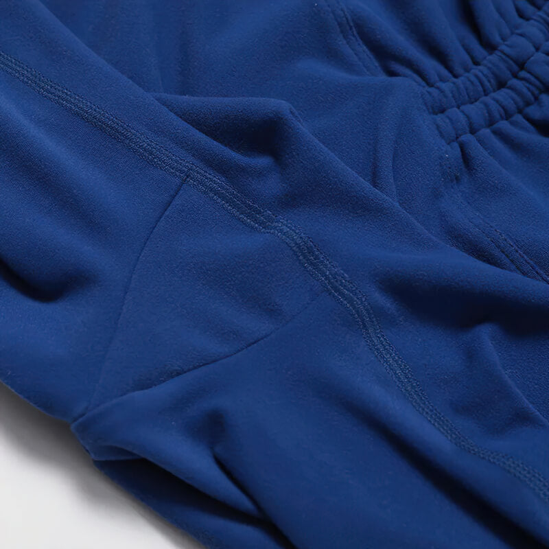 Close-up of blue fabric on high waist leggings from yoga set, showcasing breathable and anti-wrinkle features.