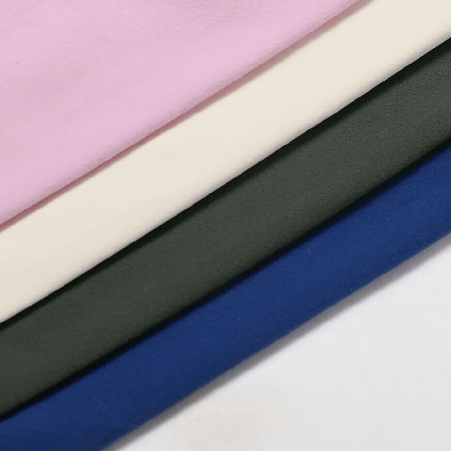 Four colorful fabric swatches in pink, cream, green, and blue, highlighting material options for a yoga set.
