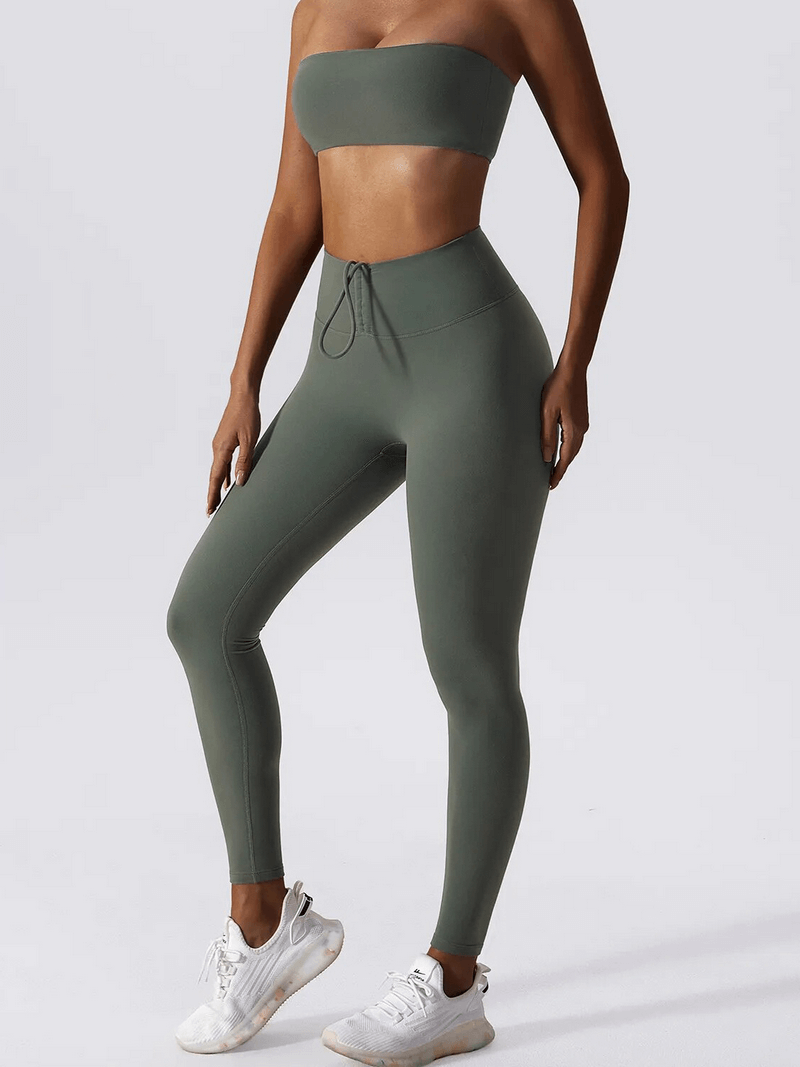 Woman wearing high waist leggings and push up sports bra yoga set in olive green, showcasing comfortable and breathable gym wear.