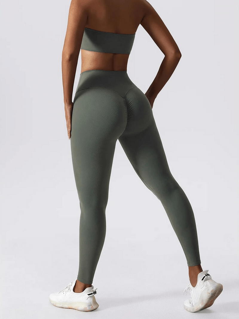 Woman modeling green high waist leggings and push up sports bra set, showcasing fitness wear with comfort and support.