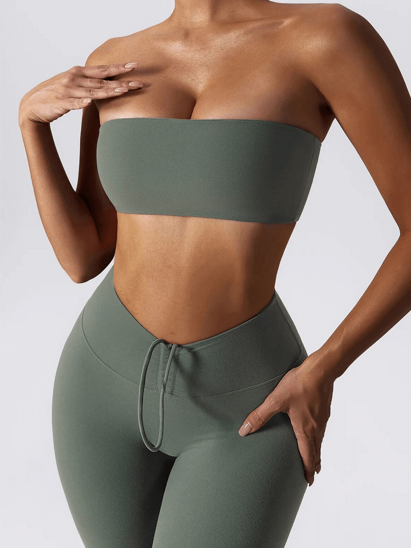 Woman wearing high waist leggings and push up sports bra in yoga set, showcasing comfortable nylon workout attire.