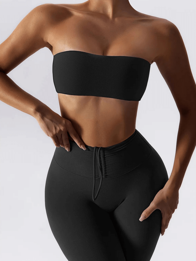 Woman wearing black high waist leggings and push up sports bra yoga set, showcasing a stylish and comfortable two-piece workout outfit.