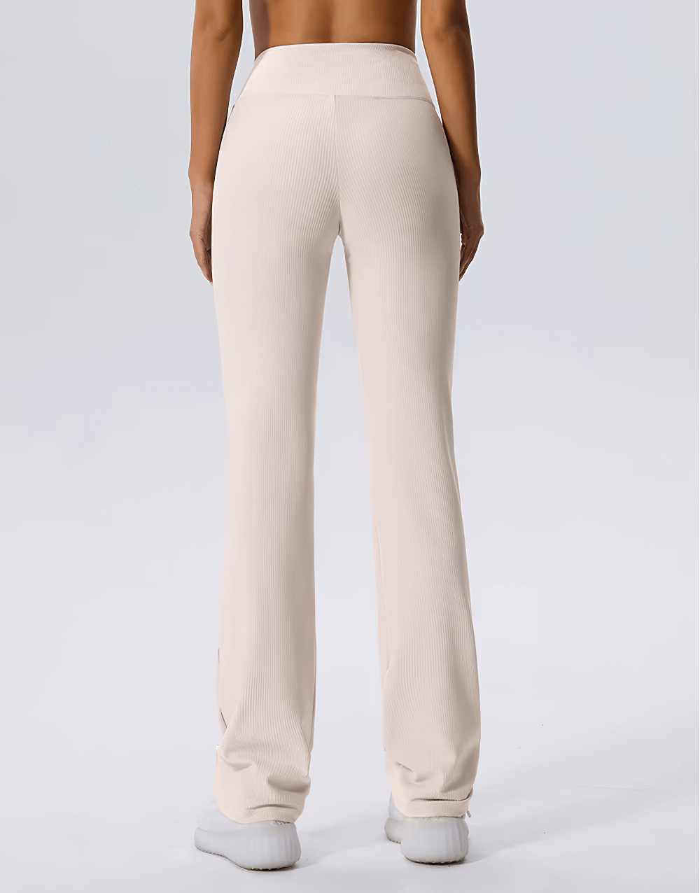 Back view of woman wearing high-waist ribbed flared yoga pants, cream color, full-length, ideal for fitness and style, SF2368.