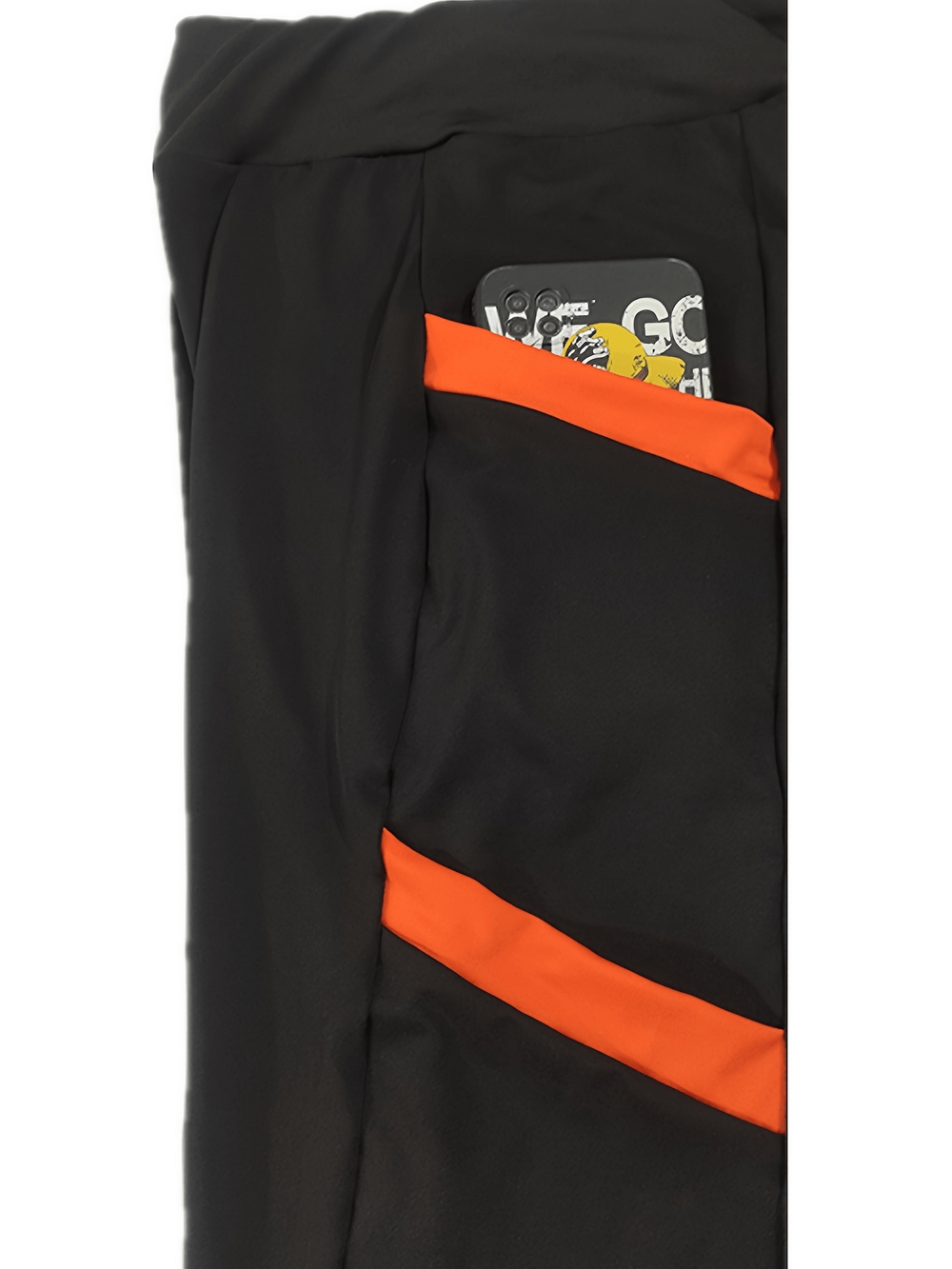 Black high waist skinny pants with bold orange side pockets and color block design, showing functional pocket with phone.