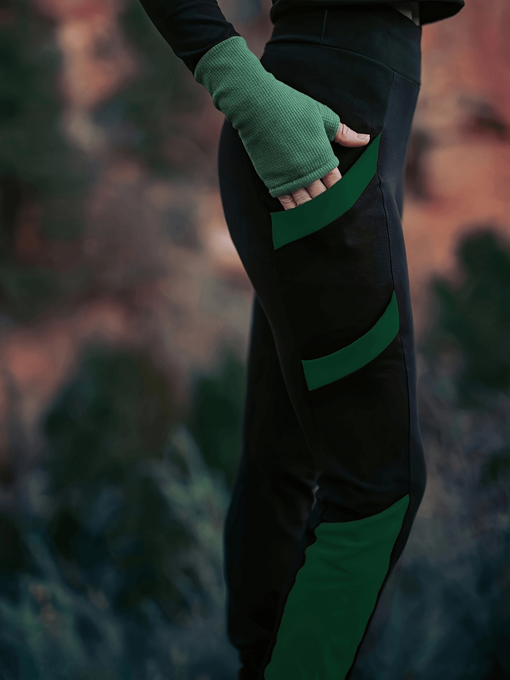 Model wearing high waist skinny pants with green color block, side pockets, and elastic waistband outdoors.