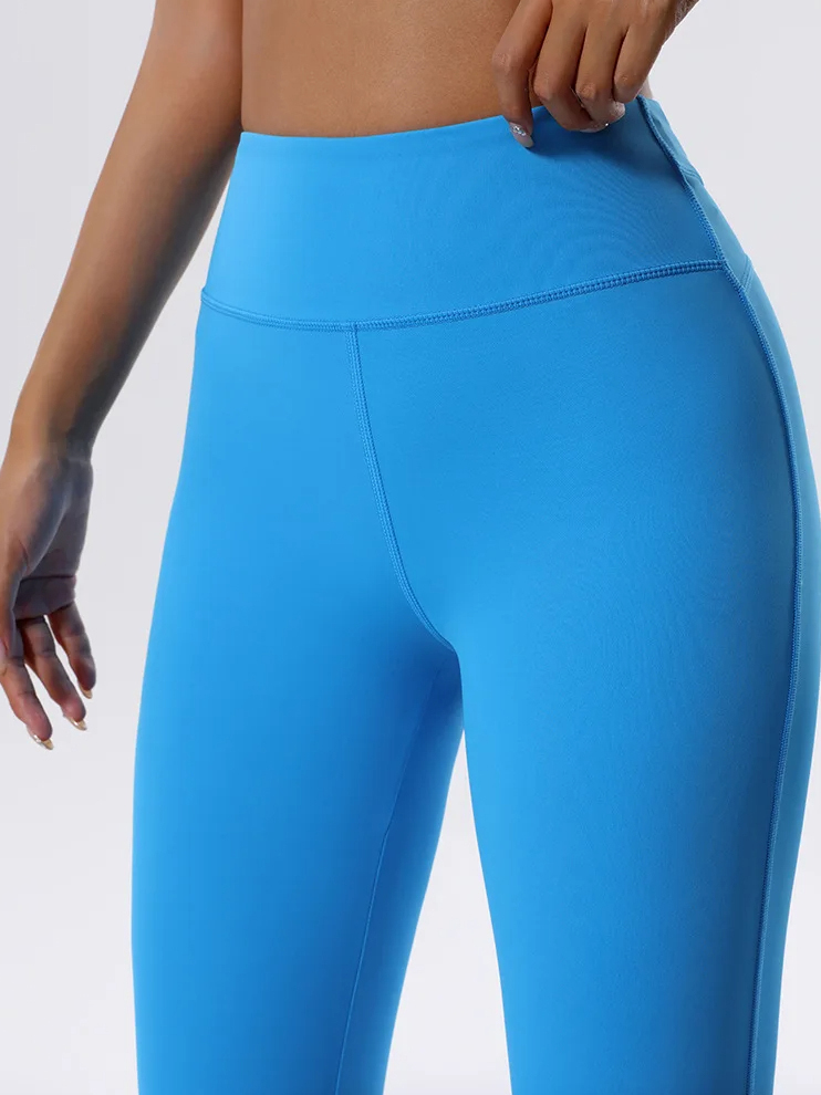 Bright blue high waist yoga pants showcasing flexibility and style, perfect for workouts and yoga.