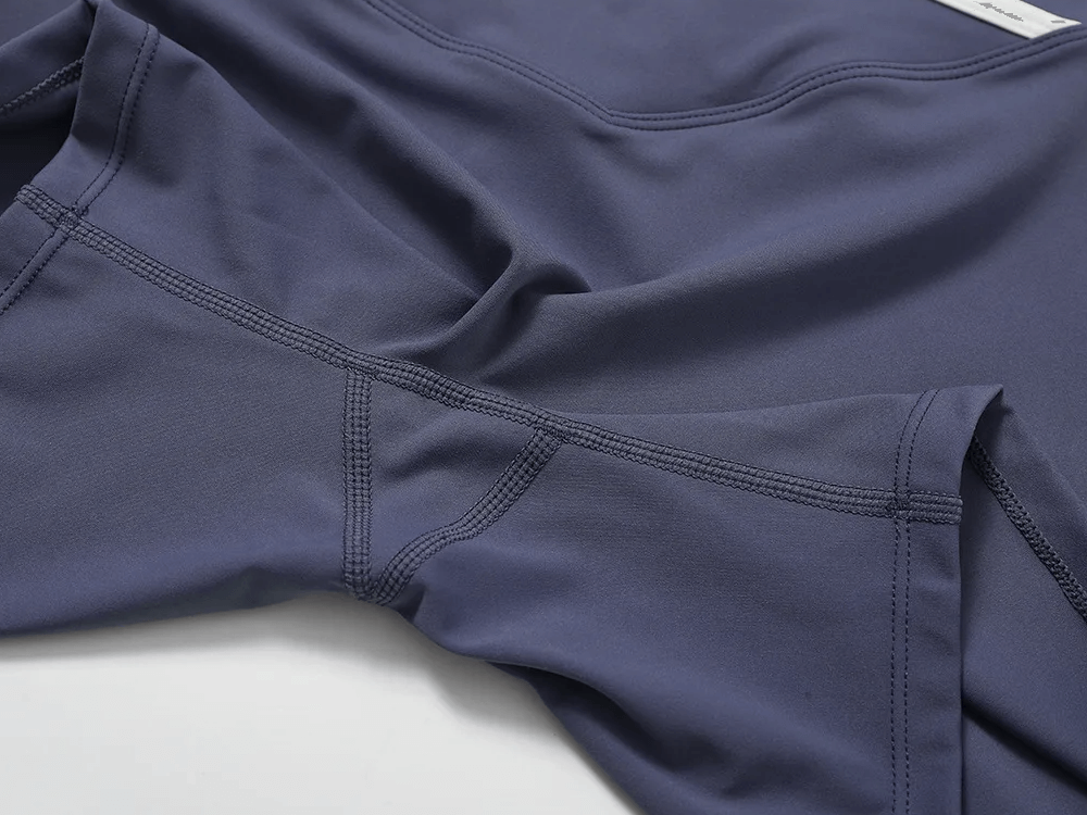 Close-up of high-waist yoga shorts with V-waist design in stretchy fabric, showcasing sleek stitch details. Ideal for activewear.