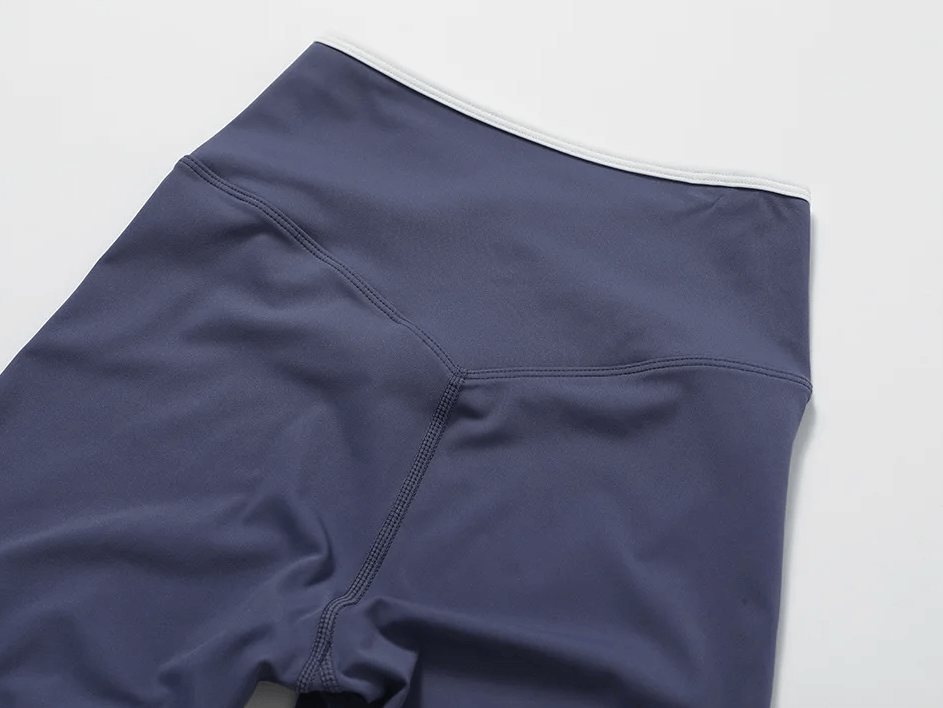 High waist navy yoga shorts with V-waist design, perfect for gym, running, or lounging, showcasing stretchy and breathable fabric.