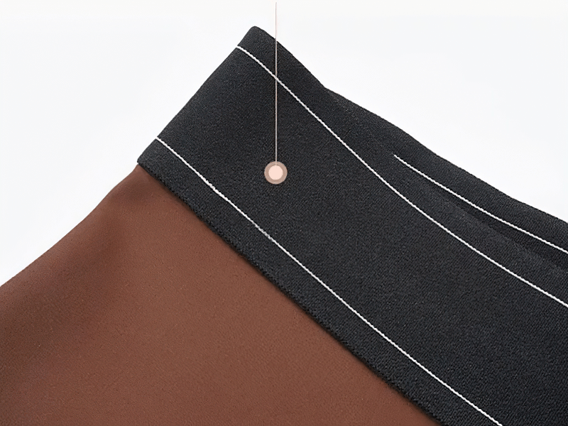 Close-up of high-waisted gym leggings featuring elastic waist and durable stitching for workout comfort.