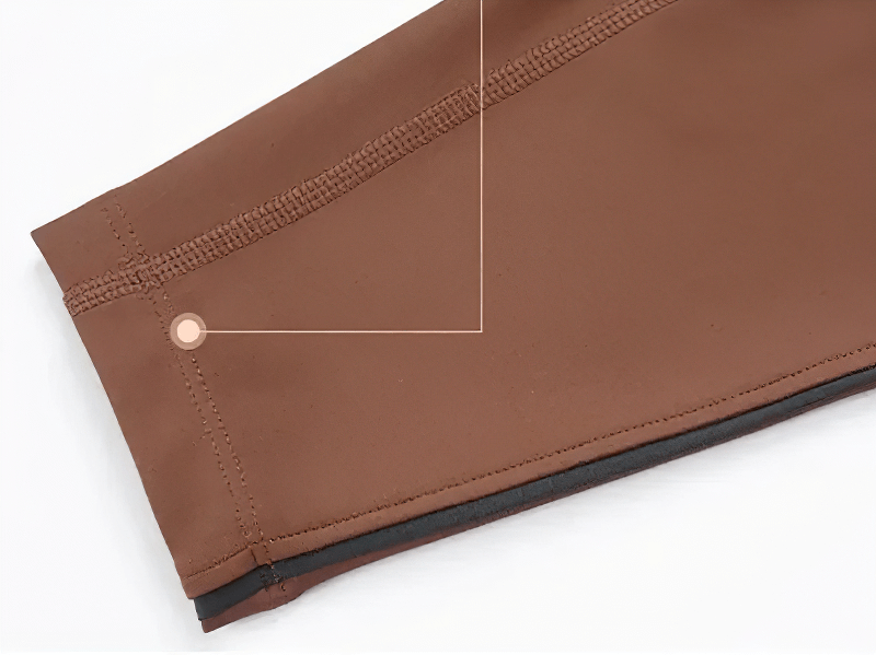 Close-up of brown high-waisted elastic gym leggings showing detailed stitching and fabric texture.