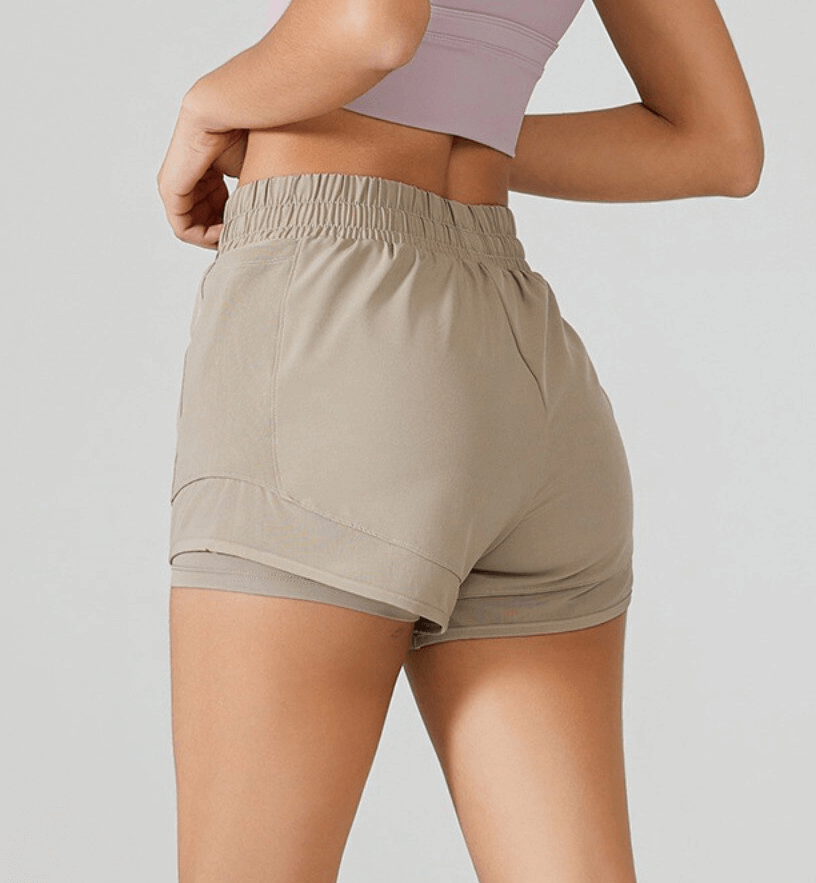 High-waisted yoga shorts for women with tummy control, showcasing secure fit and comfort in beige, perfect for workouts.