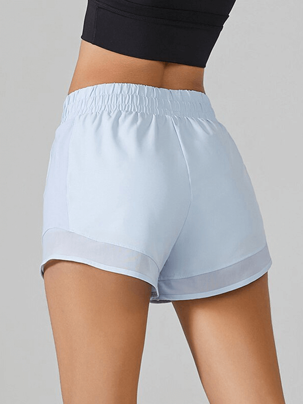 Light blue high-waisted yoga shorts for women with tummy control drawstring, perfect for workouts like Pilates and circuit training.