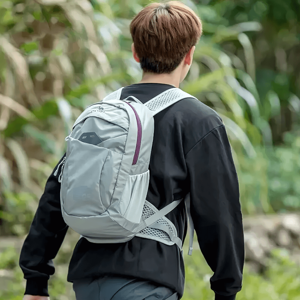 Person wearing a lightweight hiking backpack with waist pouch in outdoor setting, showcasing the SF2299's large capacity and comfort design.