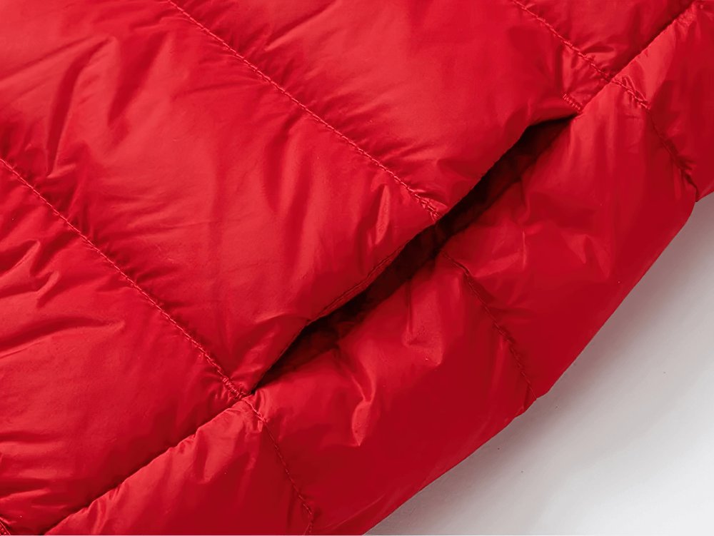 Close-up of hooded down jacket with waterproof outer shell - SF3510, showcasing vibrant red puffer design and stitching detail.