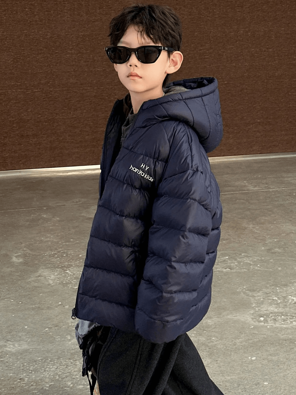 Boy wearing Hooded Puffer Jacket with Zipper and Insulation - SF3640 in blue, showcasing the jacket's padded and warm design for winter.