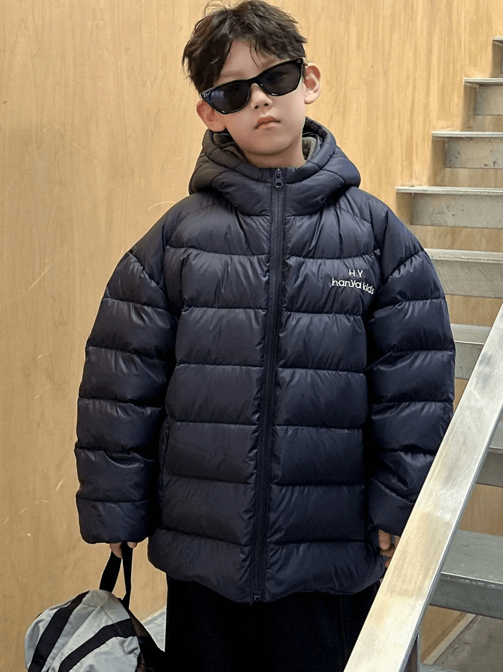 Boy wearing a Hooded Puffer Jacket with Zipper and Insulation - SF3640, keeping warm in winter outerwear.