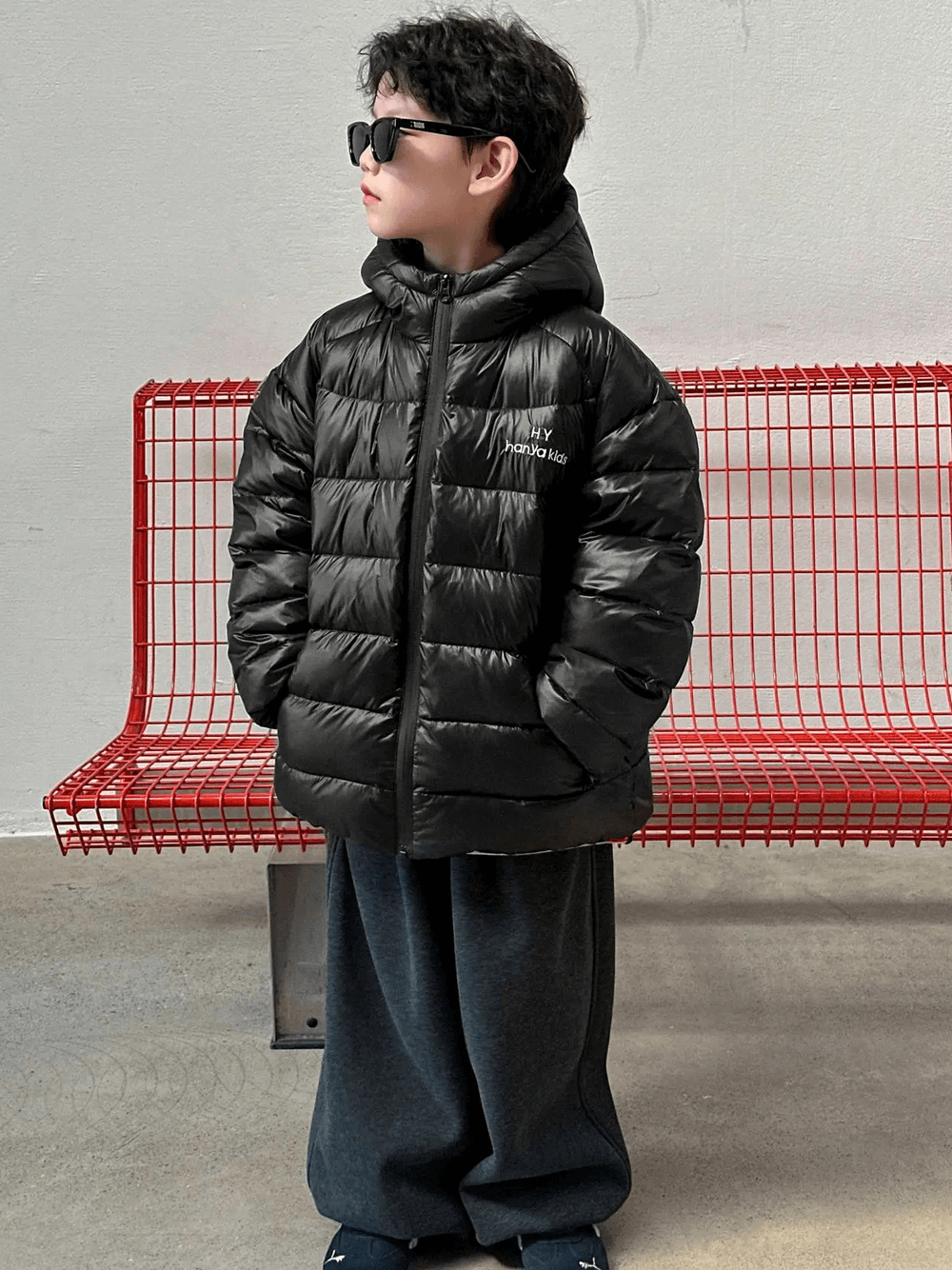 Boy wearing Hooded Puffer Jacket with Zipper and Insulation - SF3640, standing on a red bench, showcasing winter protection and warmth.