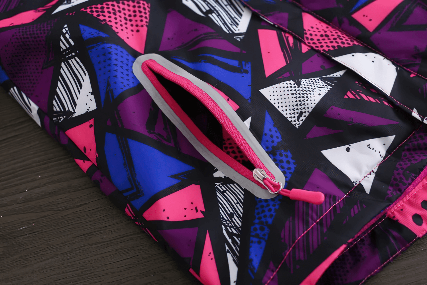 Colorful geometric design on a pocket of the Hooded Windbreaker Jacket with Camo Print - SF3847.