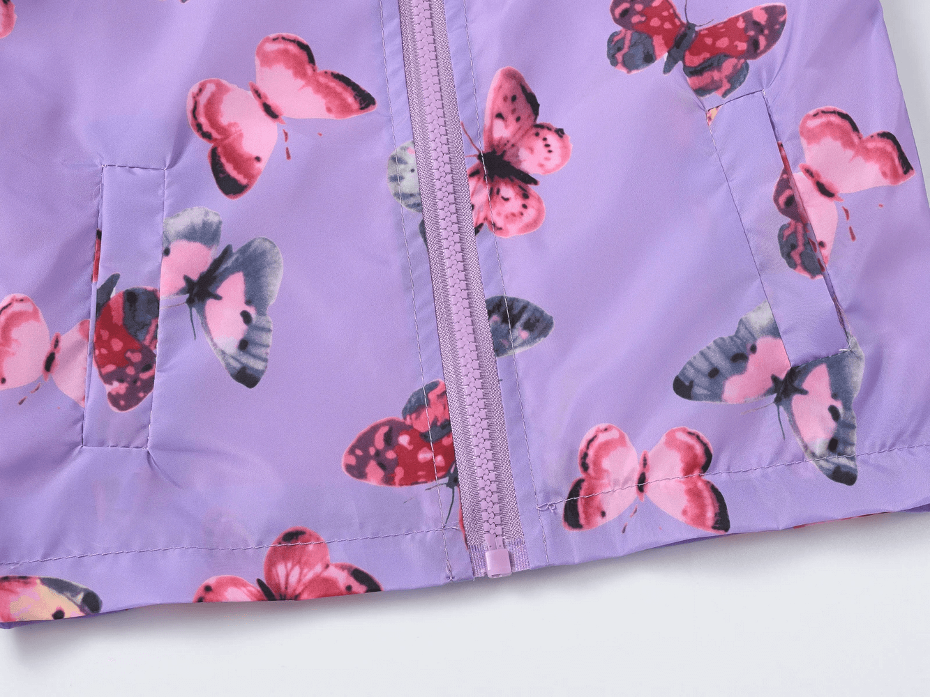 Close-up of Hooded Windbreaker Jacket with Printed Cute - SF3633, showcasing vibrant floral and butterfly prints with zipper detail.