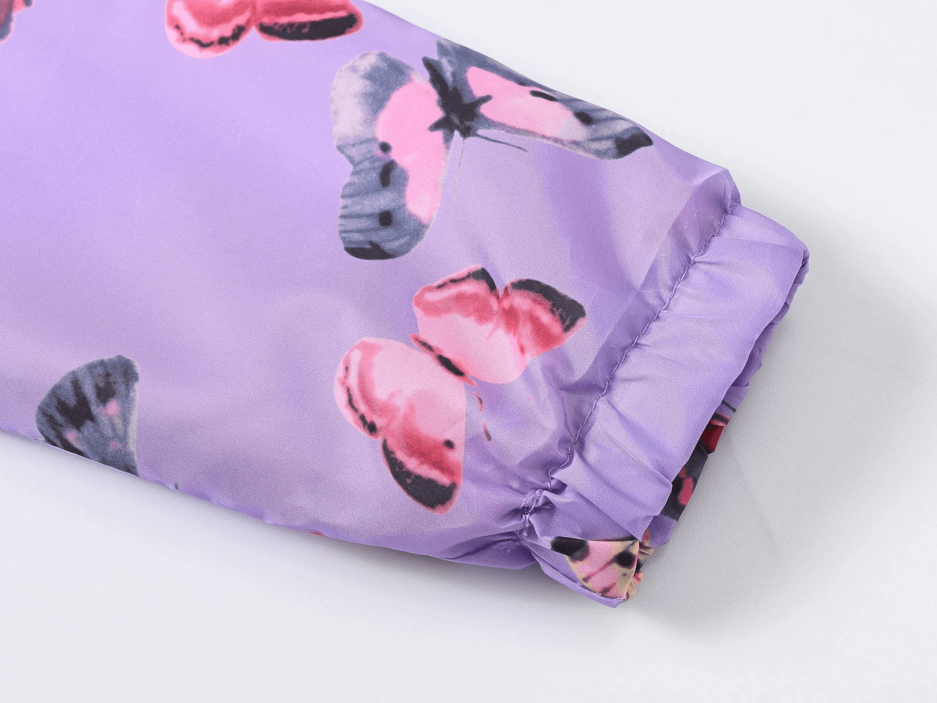 Close-up sleeve of the Hooded Windbreaker Jacket with Printed Cute - SF3633 in purple with butterfly prints, showing elastic cuff detail.