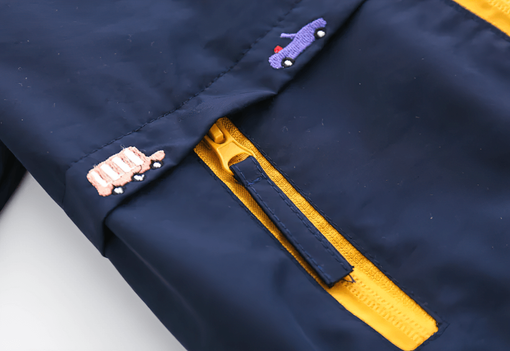 Close-up of Hooded Windbreaker Jacket with Zip Front - SF3602 showing yellow zip and cute vehicle graphics.