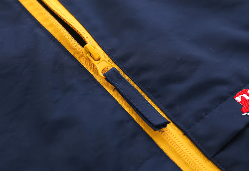 Close-up of Hooded Windbreaker Jacket with Zip Front - SF3602 featuring a bold yellow zipper.