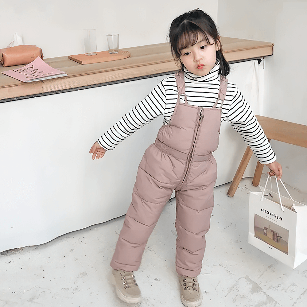 Cute child wearing Insulated Snow Bib Pants for Boys and Girls - SF3731, perfect for winter play and skiing with durable and warm design.