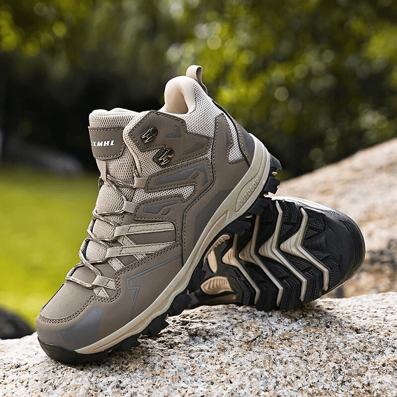 Comfortable waterproof unisex leather hiking boots with cushioning, shown on rocky terrain, perfect for stability and grip.