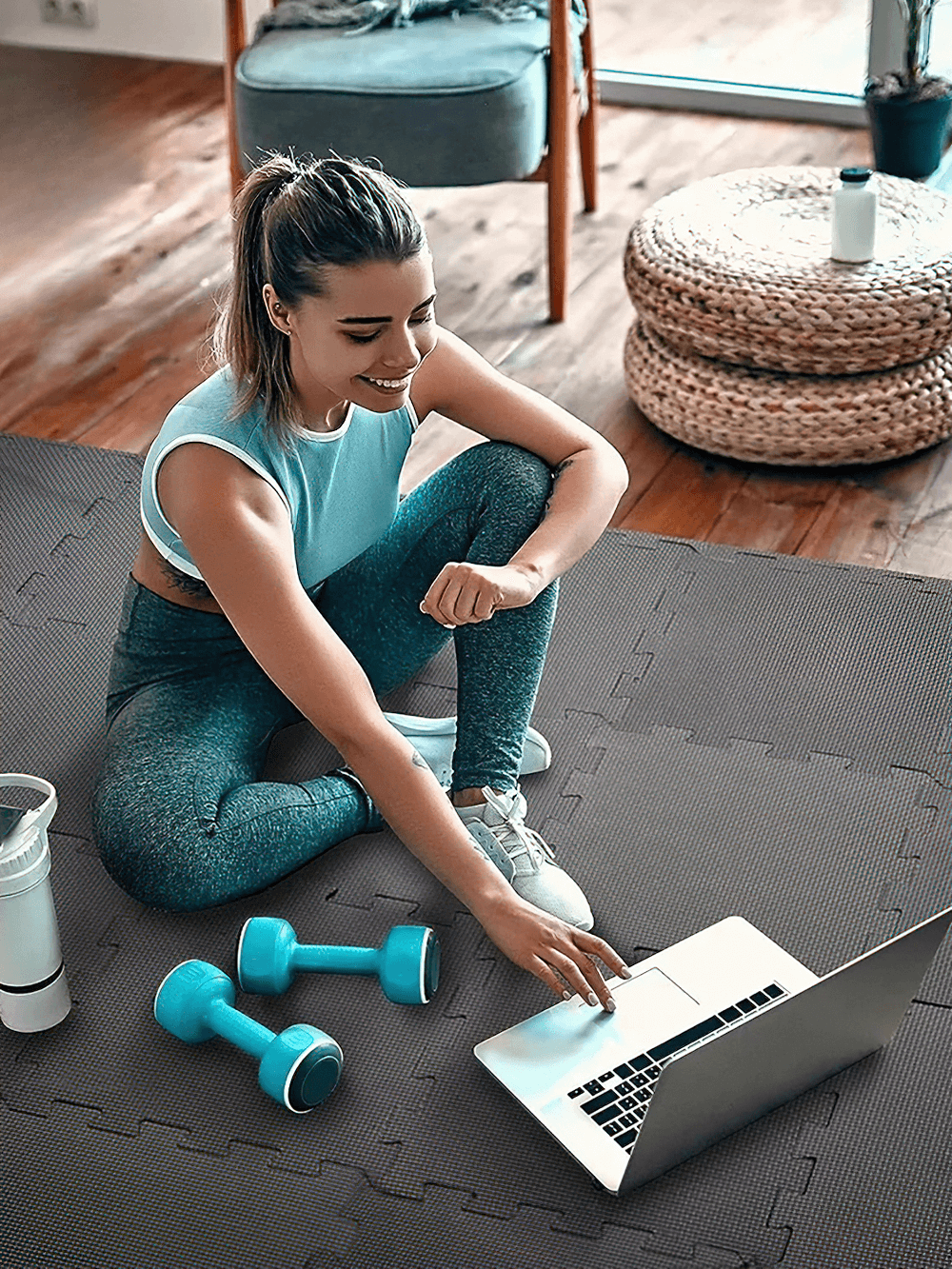 Woman exercising on Interlocking EVA Foam Floor Mat Tiles Set - SF3472 in home gym, with laptop and dumbbells.