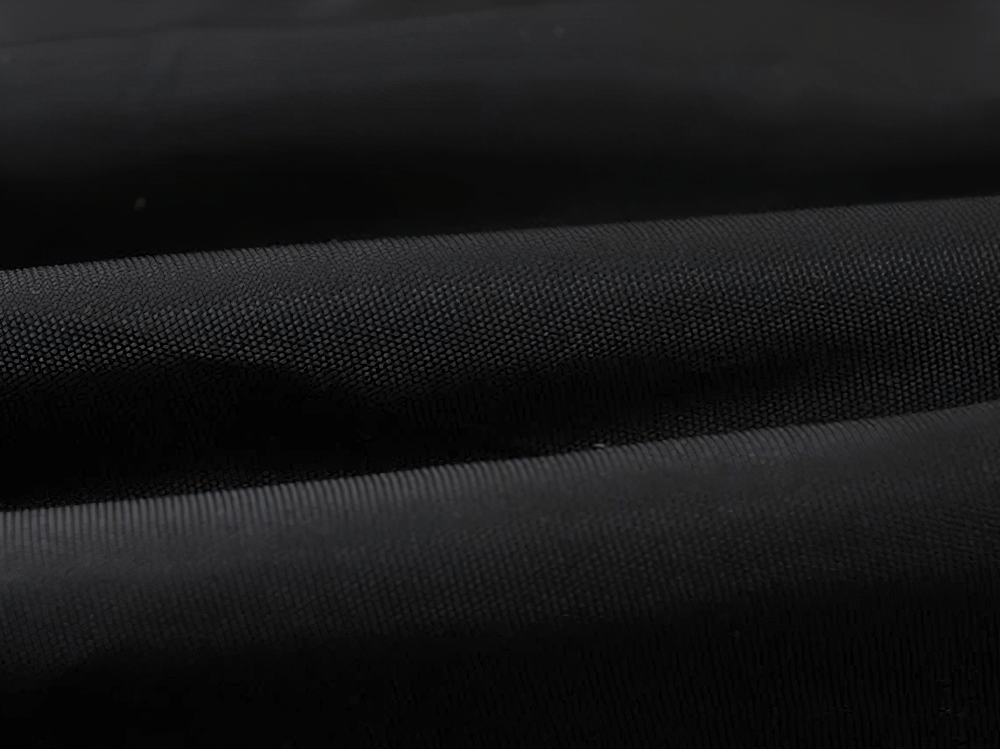 Close-up of fabric from Kids Camouflage Hooded Windbreaker Jacket - SF3642, showcasing durable, padded material for warmth and protection.