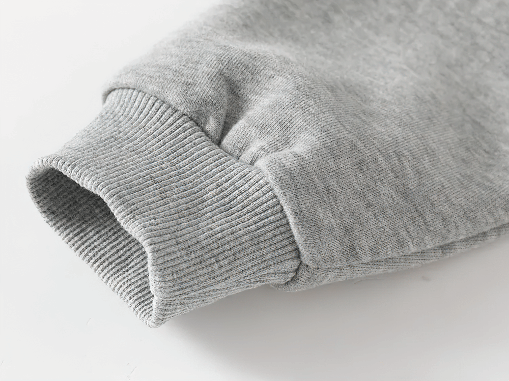 Close-up of a gray ribbed cuff on a Kid's Casual Detachment Semester Sweatshirt, showcasing soft cotton fabric detail.