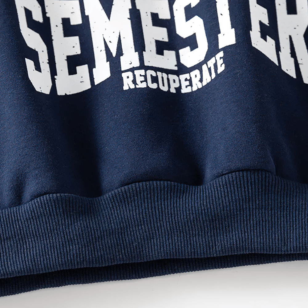 Close-up of Kid's Detachment Semester Sweatshirt with bold printed slogan in white on navy, crafted from soft cotton fabric.