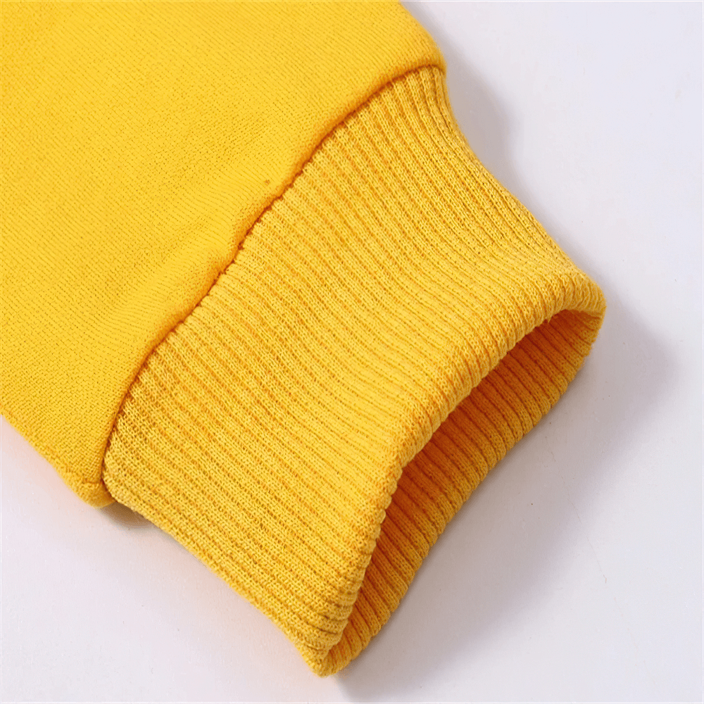 Close-up of yellow kids casual hoodie sleeve cuff, soft and comfortable for everyday wear.