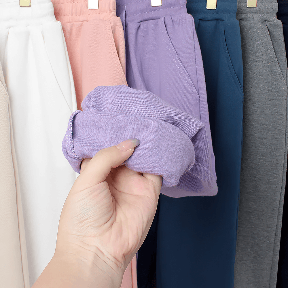 Various colors of Kids Casual Sports Jogger Pants with Pockets - SF3612 fabric sample in hand.