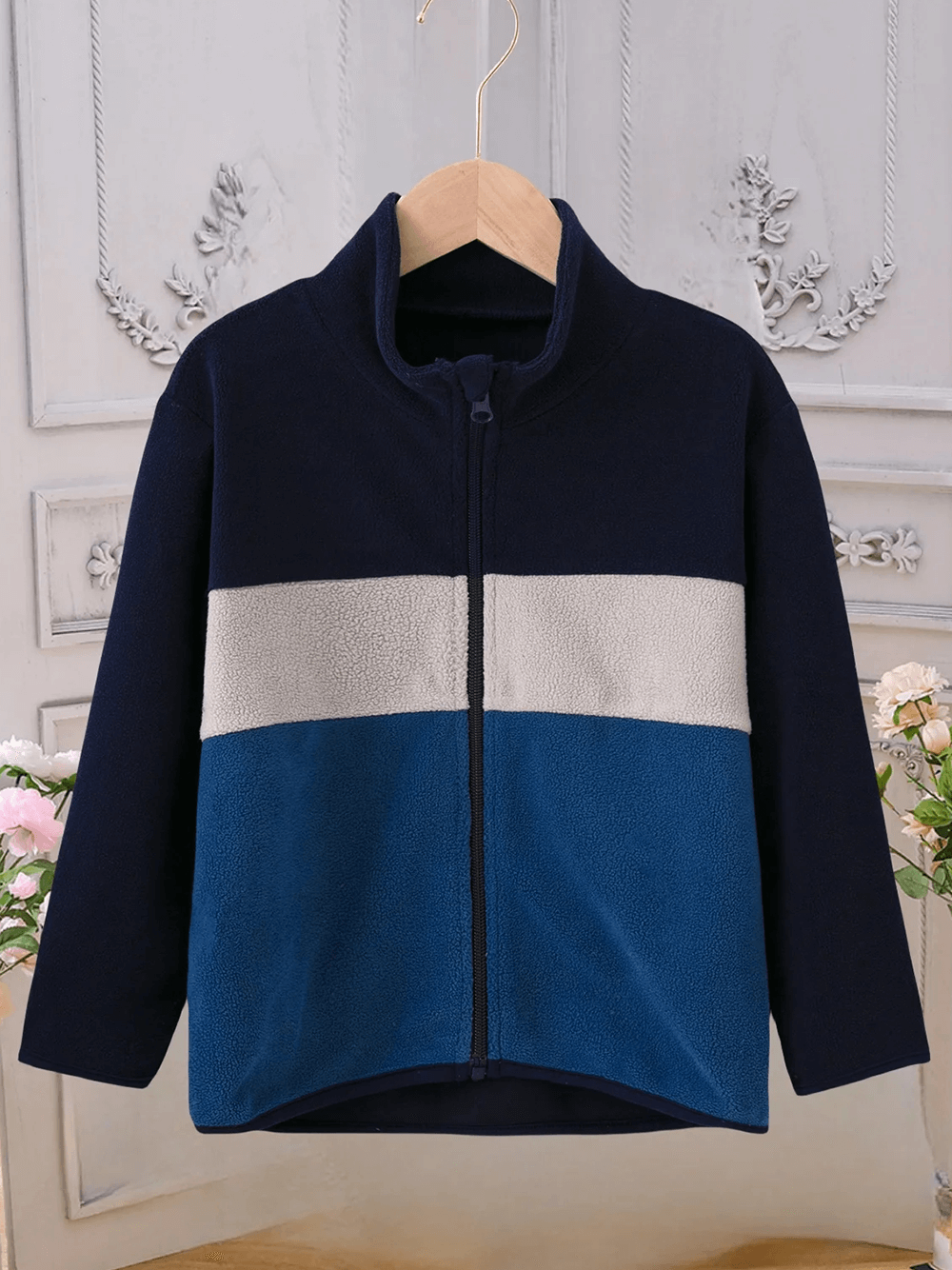 Kids Color Block Fleece Jacket with Stand Collar - SF3858 hanging in a stylish setting.