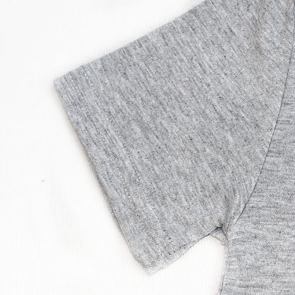Close-up of a grey cotton O-neck short-sleeved T-shirt, showcasing breathable fabric and relaxed fit for kids.