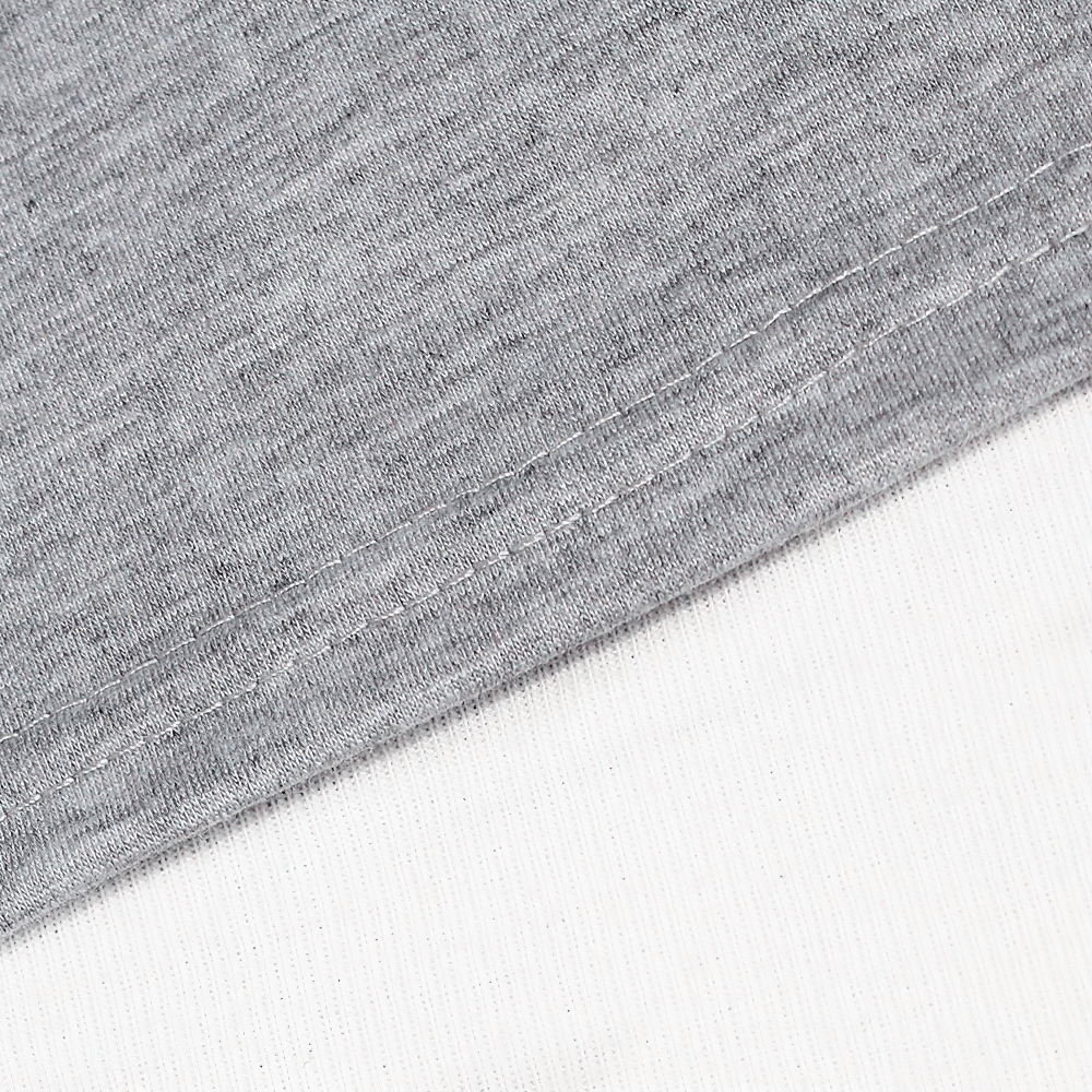 Close-up of the hem and fabric texture of a kids cotton O-neck short-sleeved T-shirt in gray and white, showcasing quality stitching.