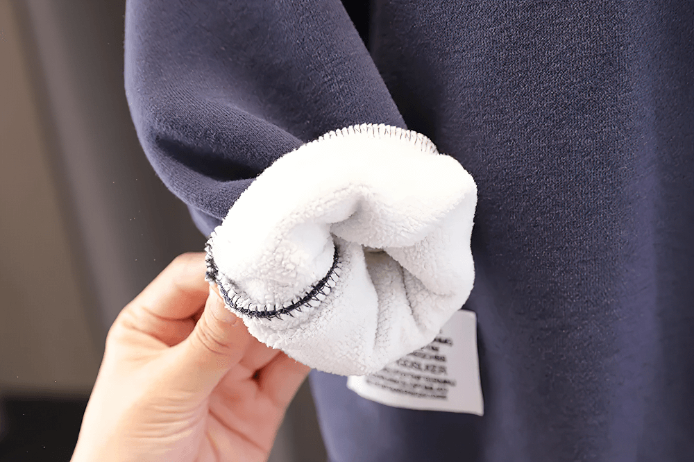 Close-up of the soft lining inside the Kids Cozy Hoodie with Cute Horn Detail - SF3764, showcasing its plush fabric and stitching detail.